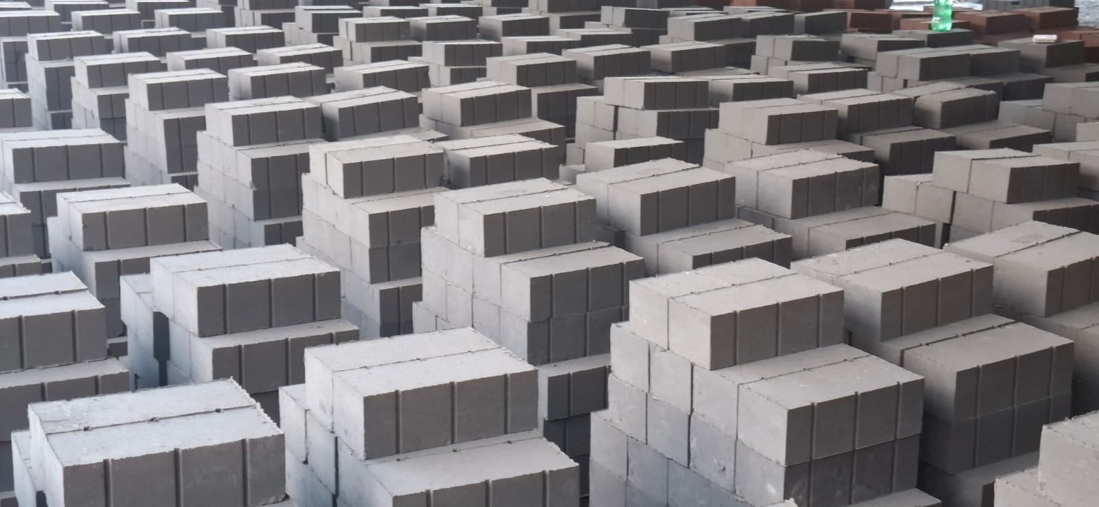 Stacks of premium grey flyash bricks at TVM Brick Industries yard in Thondamuthur, Coimbatore